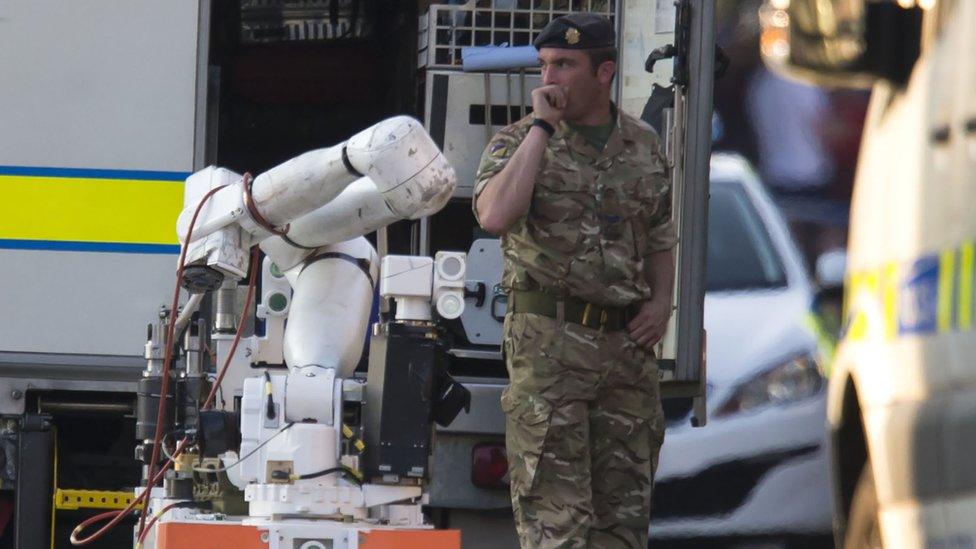 An army bomb disposal unit is parked nearby during a security operation at Springfield Street in Wigan