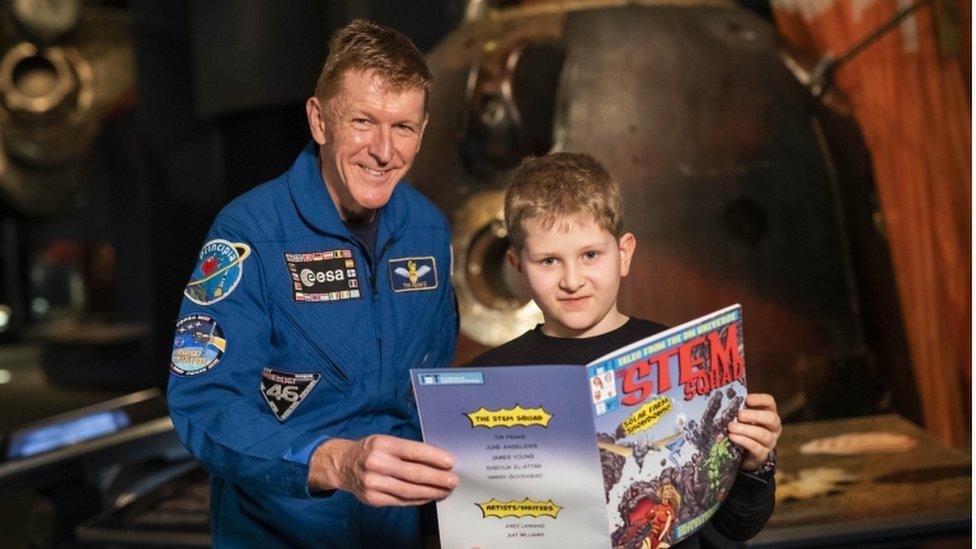 Harry and Tim with a copy of the comic.