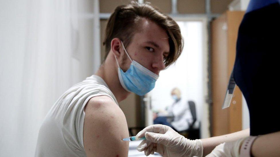 A member of the Novosibirsk Ice Hockey club receives an injection