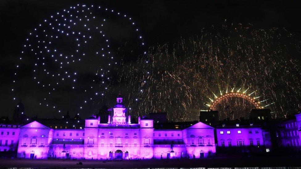 Drones gather to create profile of Queen Elizabeth II while fireworks light up the London Eye.