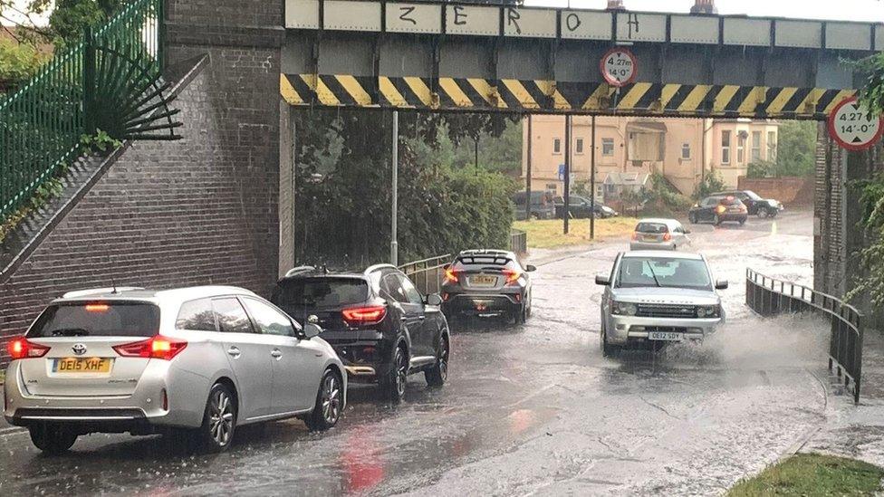 Cars driving through floodwater on Gringer Hill in Maidenhead