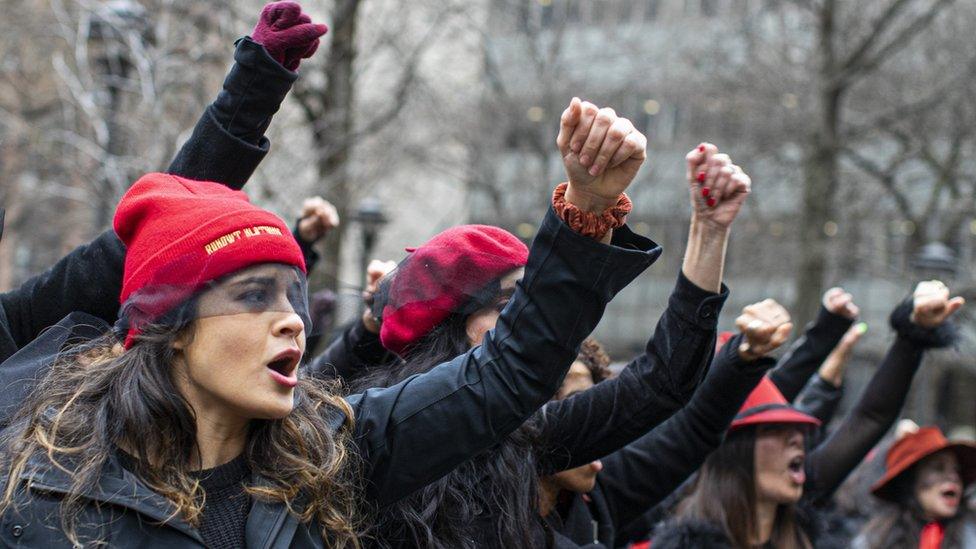 Women protest against rape as they sing a song in front of the court while Harvey Weinstein attends a pretrial session on January 10, 2020 in New York City