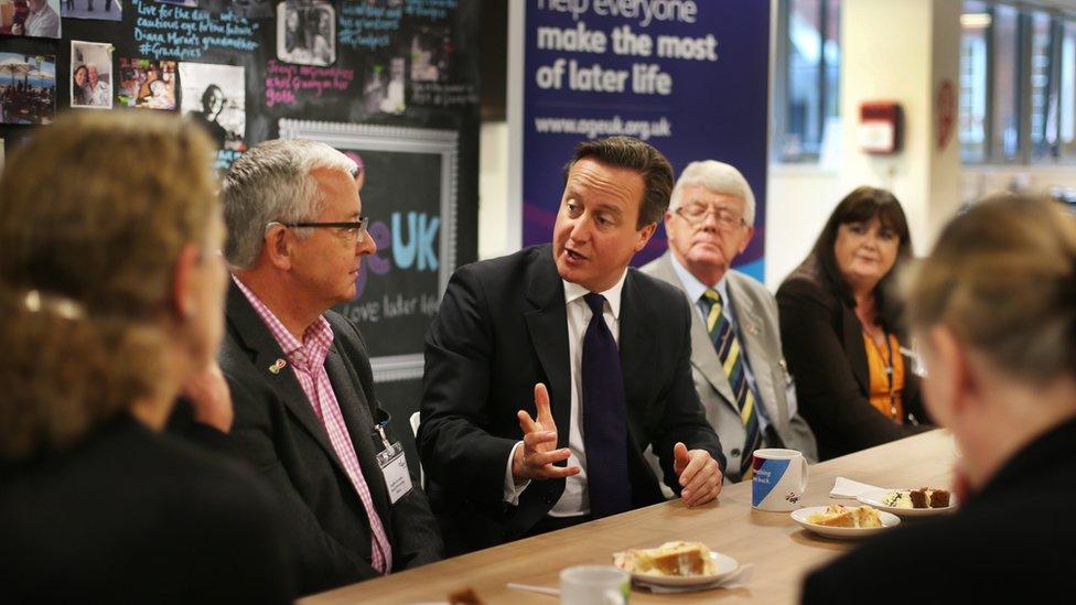 Prime Minister David Cameron talks to pensioners and older working people at Age UK headquarters on October 14, 2014