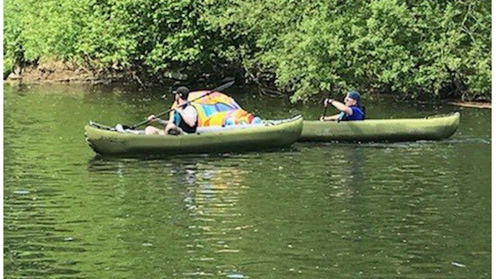 The duck sculpture and the two canoeists