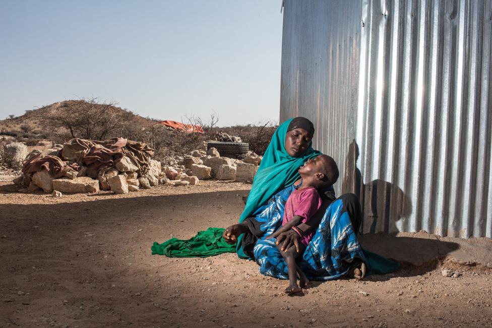 Hodan, a mother of five, holds her two year old son Harun in the town of Kiridh, Somaliland.