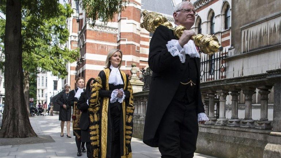 A ceremonial procession leads Liz Truss to the Royal Courts of Justice