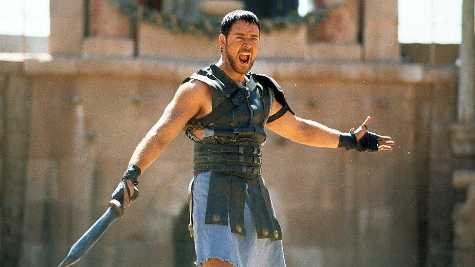 Russell Crowe with a sword in a scene from the 2000 film Gladiator