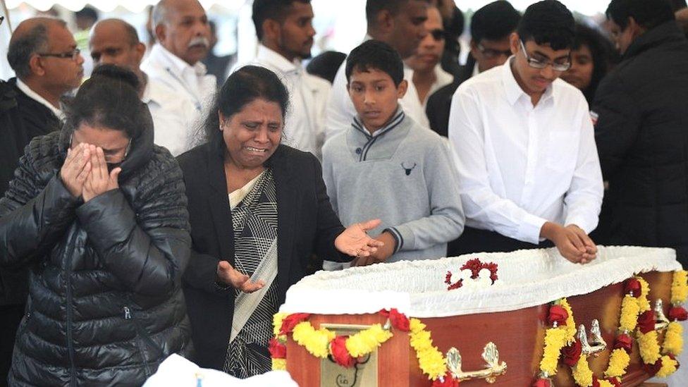 Mourners view the open coffin of Gurushanth Srithavarajah