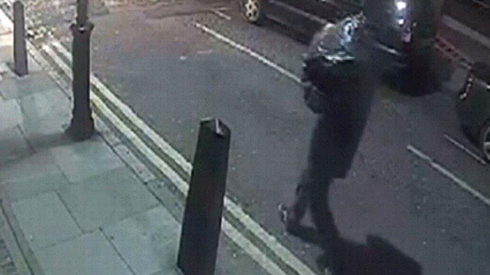 CCTV of person carrying bin bag