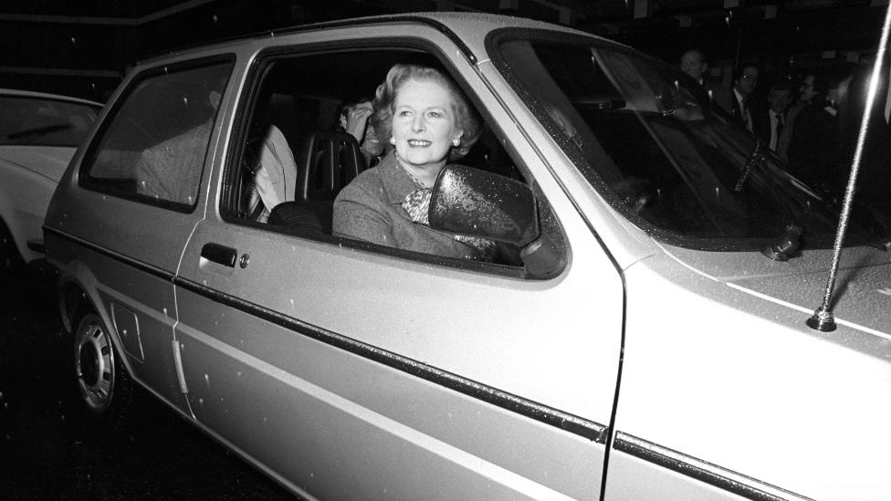 Prime Minister Margaret Thatcher driving a Metro