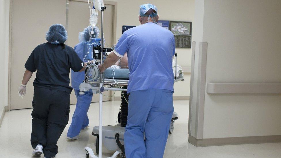 Hospital staff with a patient on a trolley