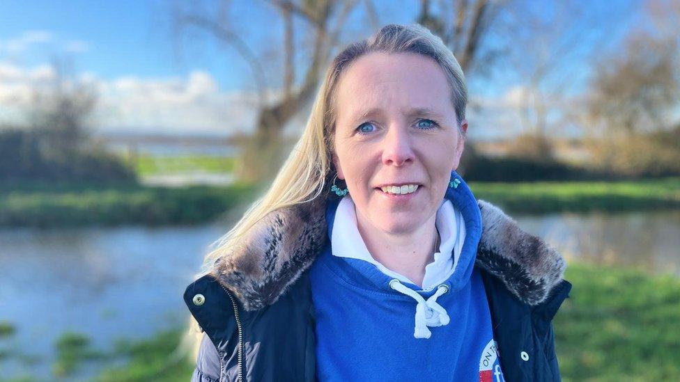 A women in front of flood water