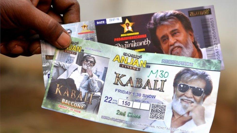 A fan shows movie tickets for Indian actor Rajinikant"s latest movie "Kabali" on the eve of the movie"s release, in Bangalore on July 21, 2016