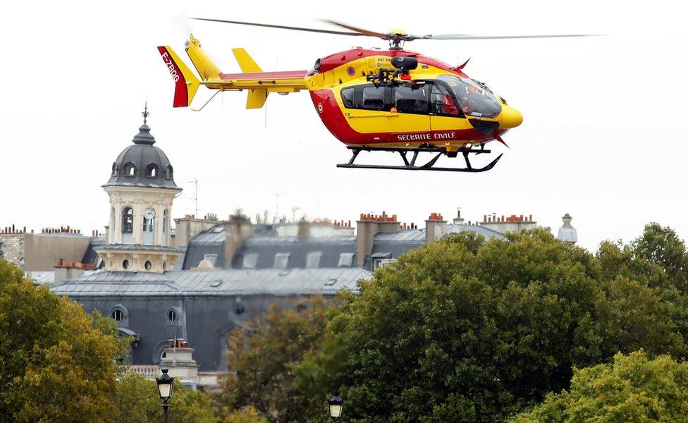 A rescue helicopter is seen after an attack on the police headquarters in Paris.