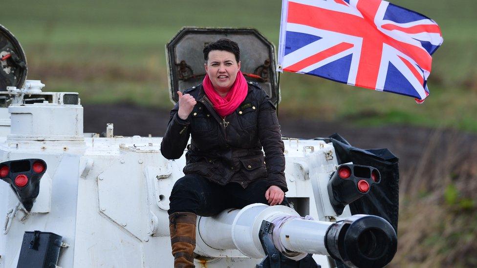 Ruth Davidson on a tank with a Union Jack flag