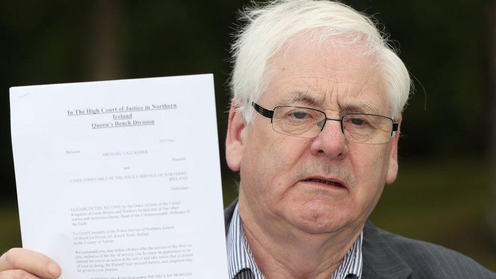 Michael Gallagher, who lost his son Aiden in the Omagh bombing, holds a writ in the Omagh Memorial Garden.