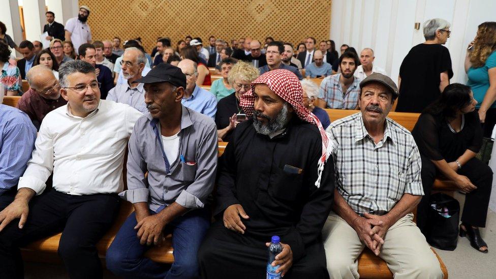 Residents of Khan al-Ahmar sit inside the Israeli Supreme Court building in Jerusalem on 1 August 2018