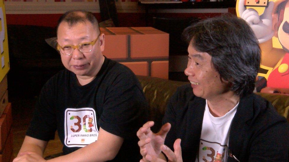 Shigeru Miyamoto and Takashi Tezuka sitting on a sofa