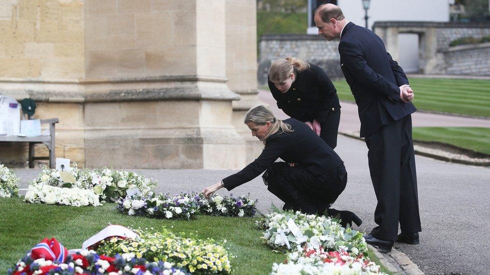 The Countess of Wessex, Lady Louise Windsor and the Earl of Wessex view flowers outside St George's Chapel, at Windsor Castle, on 16 April 2021