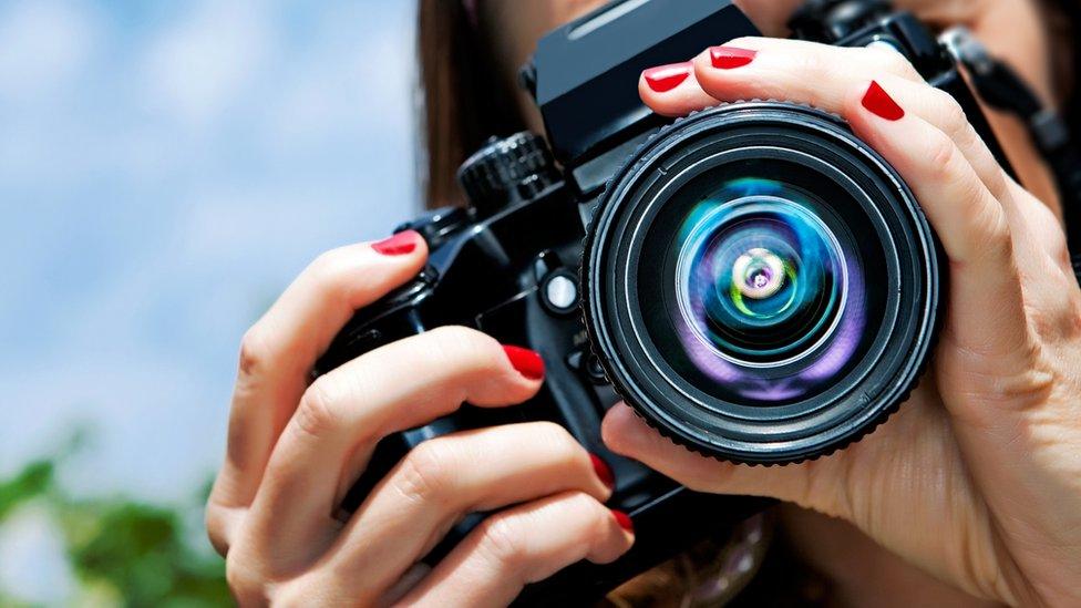 Woman holding a camera