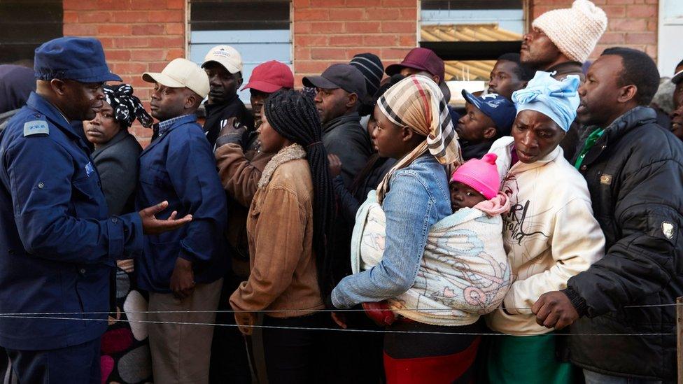 People queue early morning on 30 July 2018 at a polling station in the Harare suburb of Chitungwiza, Zimbabwe