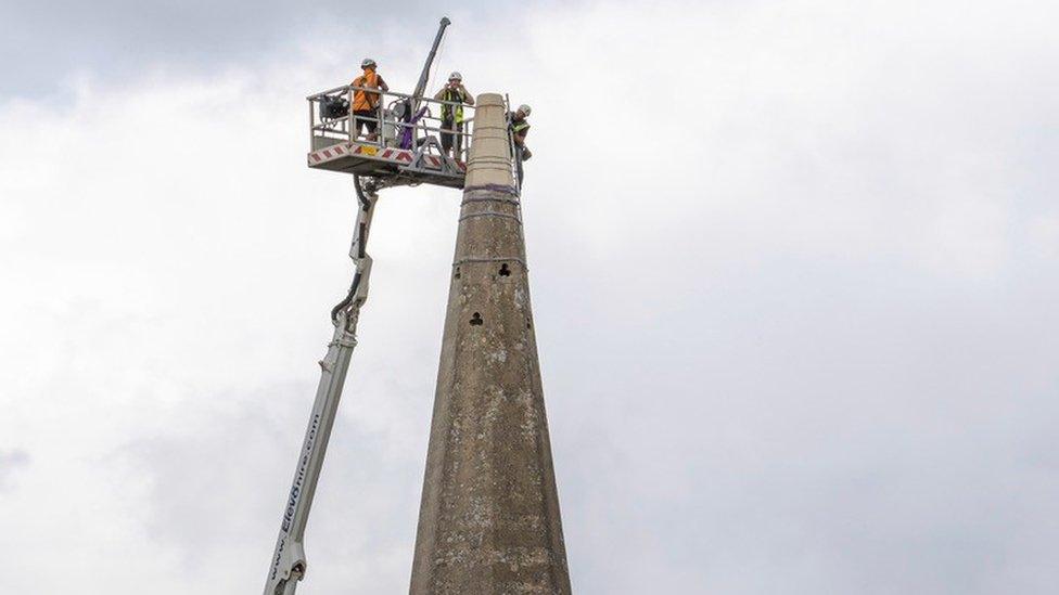 Workers mending the church spire