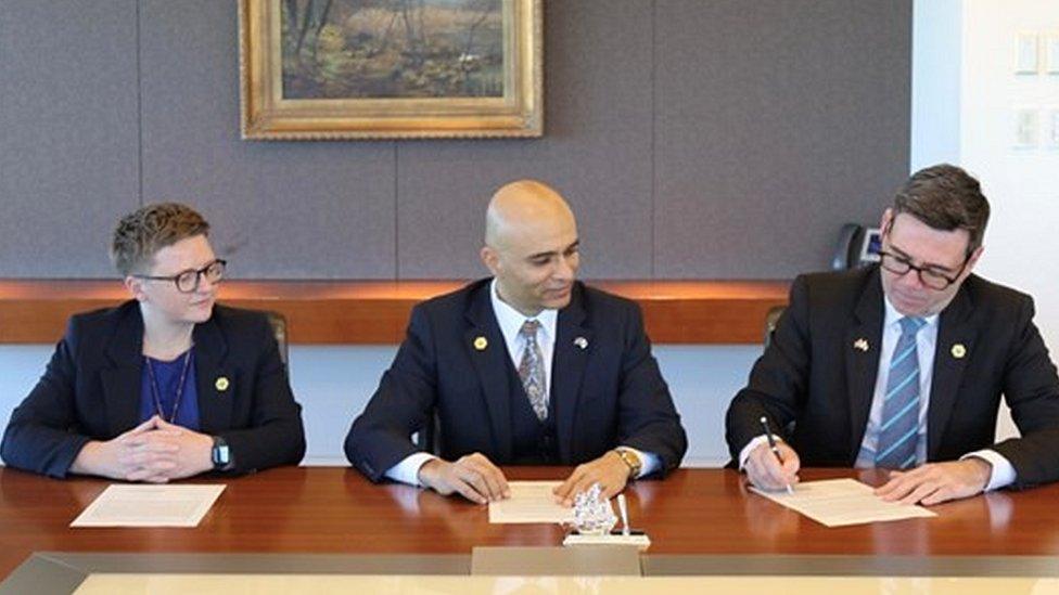 (Left to right) Councillor Bev Craig, Vivek Mahajan from Fujitsu and Mayor Andy Burnham sign the agreement