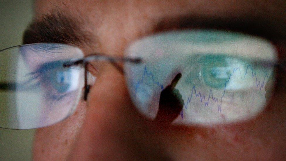 reflections in trader's glasses