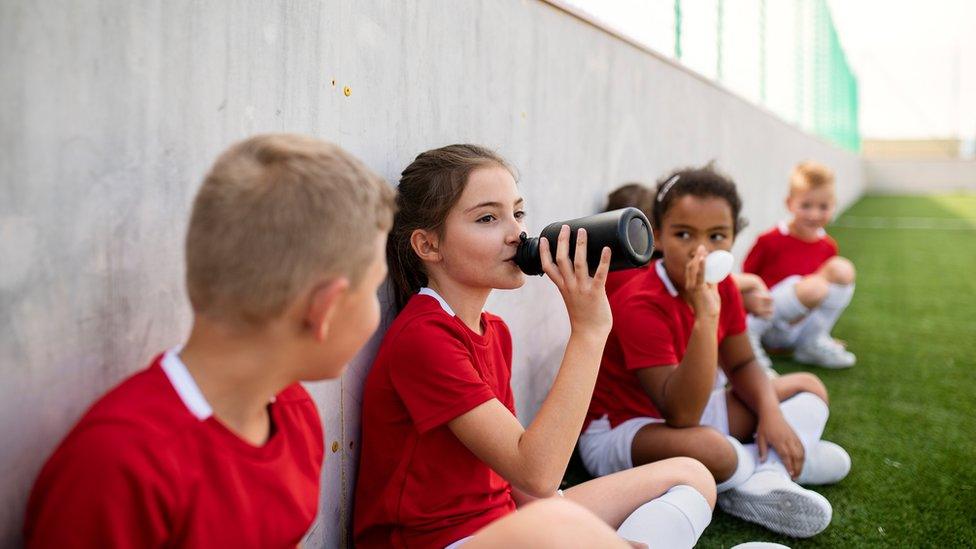 Children taking a break while playing sport