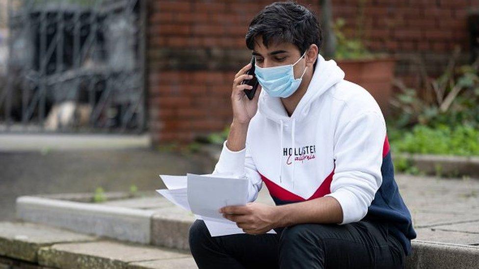 boy on phone with results in hand