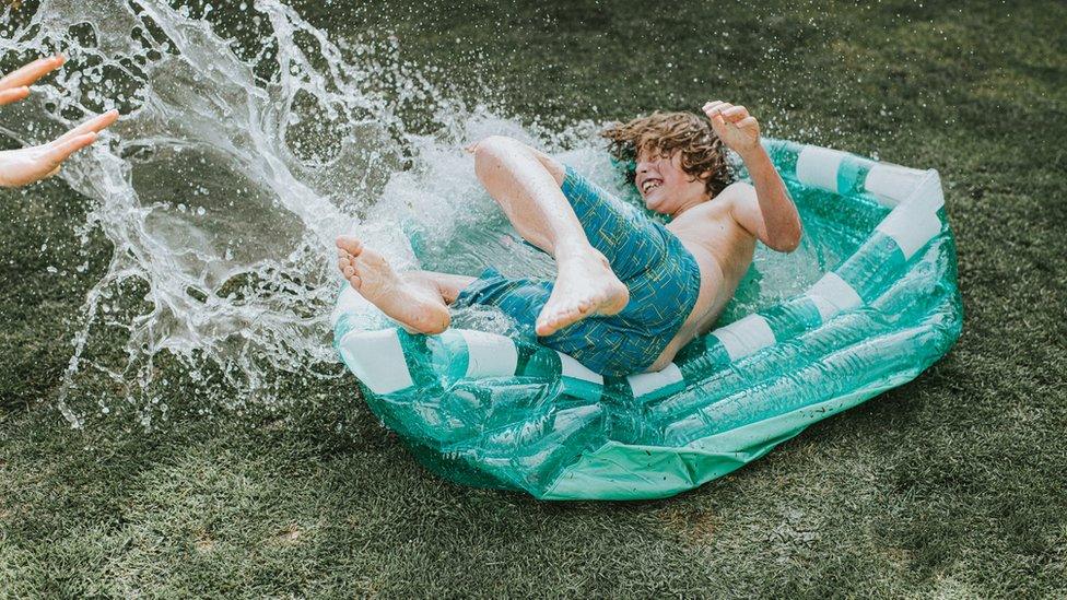 boy in paddling pool