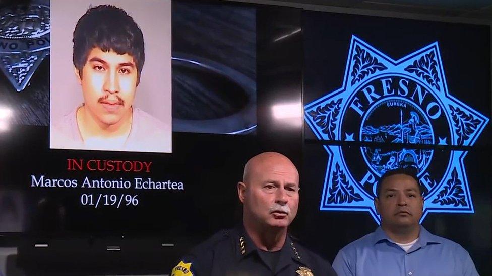 Police Chief Jerry Dyer talking at a press conference with a picture of suspect Marcos Echartea behind him