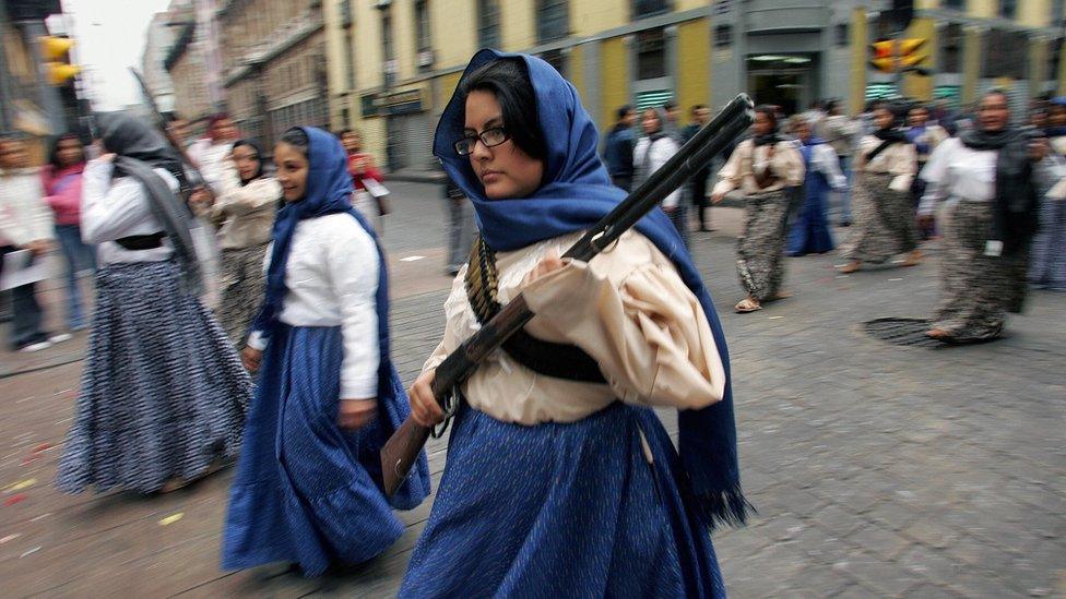 Actresses clad as "soldaderas", soldier-women during the Mexican Revolution, take part in the parade commemorating the 96th anniversary of the Mexican Revolution