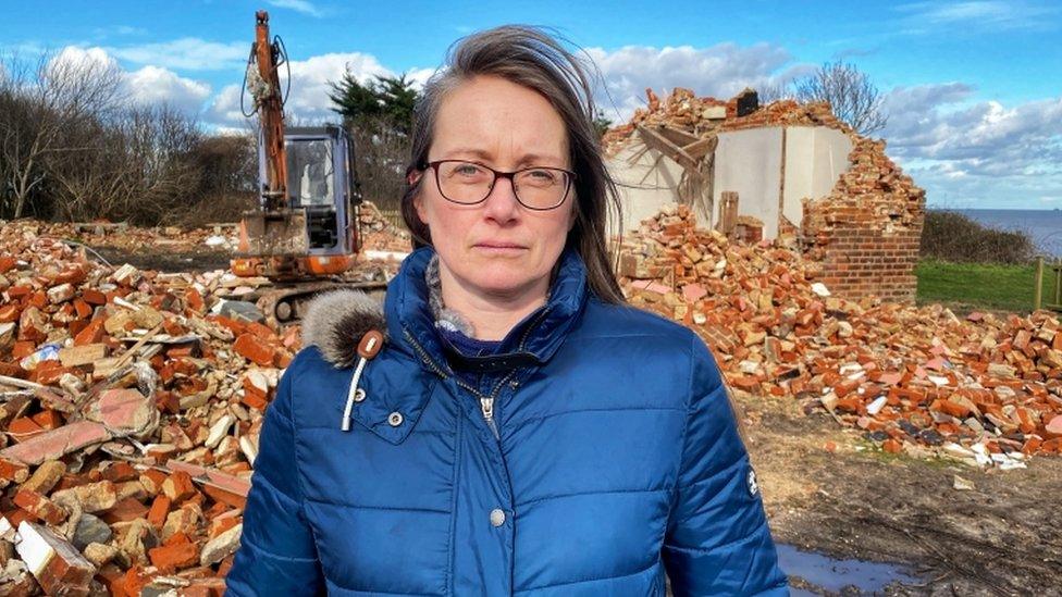 Anne Jones in front of rubble at Easton Bavents