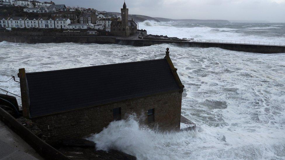 Waves crash into the seafront in Portlevenin, Cornwall