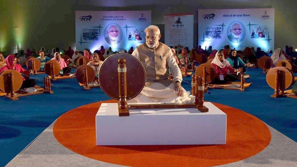 Mr Modi with traditional cotton spinning wheel