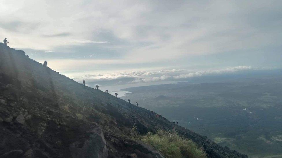 Rescuers climb Mayon Volcano searching for a crashed Cessna 340.