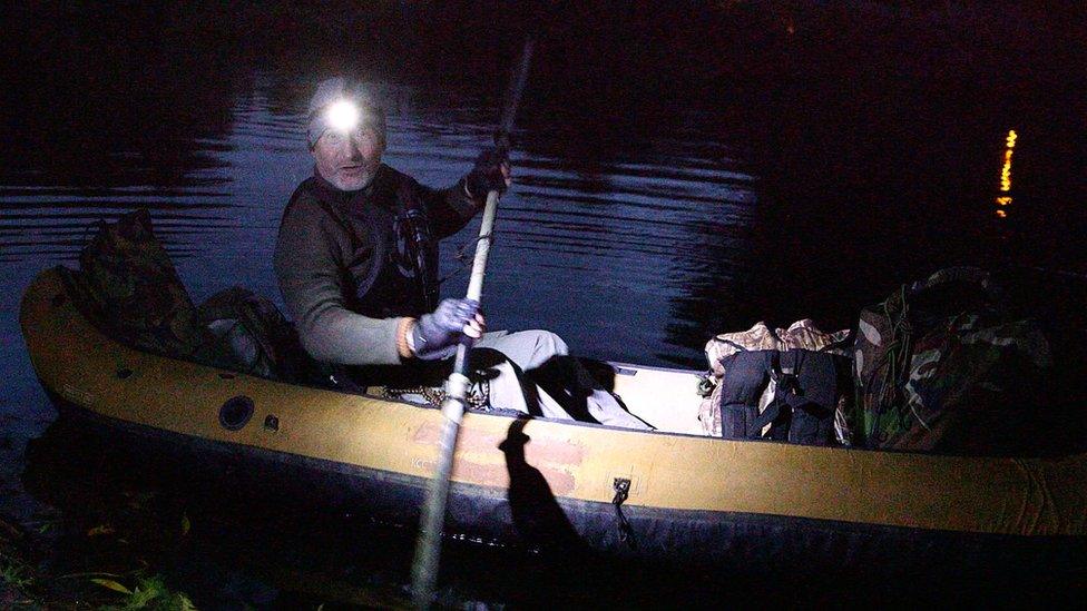 Peter Stanford in his canoe after sunset