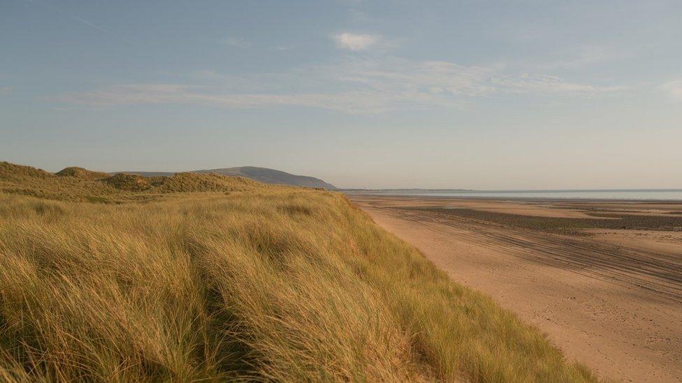 A view of sand dunes and a pretty beach