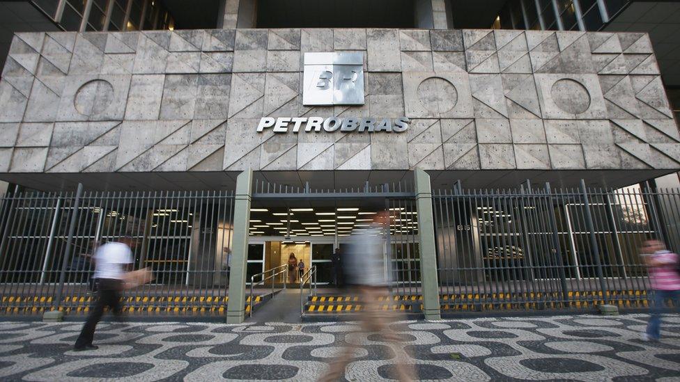 People walk past Petrobras' headquarters