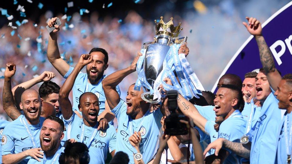 Manchester City Players lift the Premier League trophy