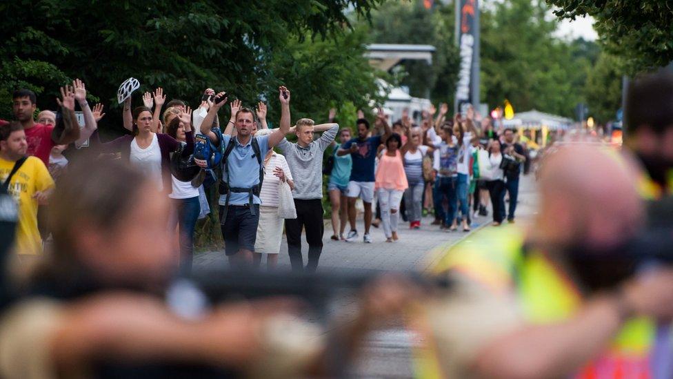 Crowds of people come out of the shopping centre