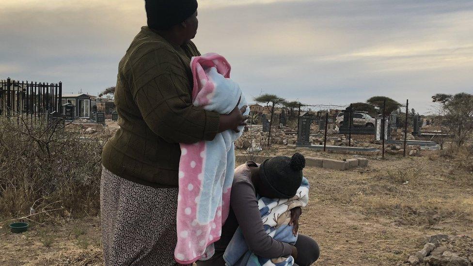 Kholofelo Moholola and her grandmother in a local cemetery