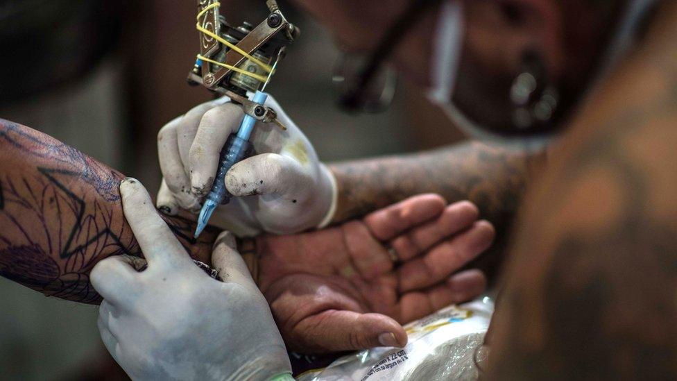 Man having a tattoo done on his arm