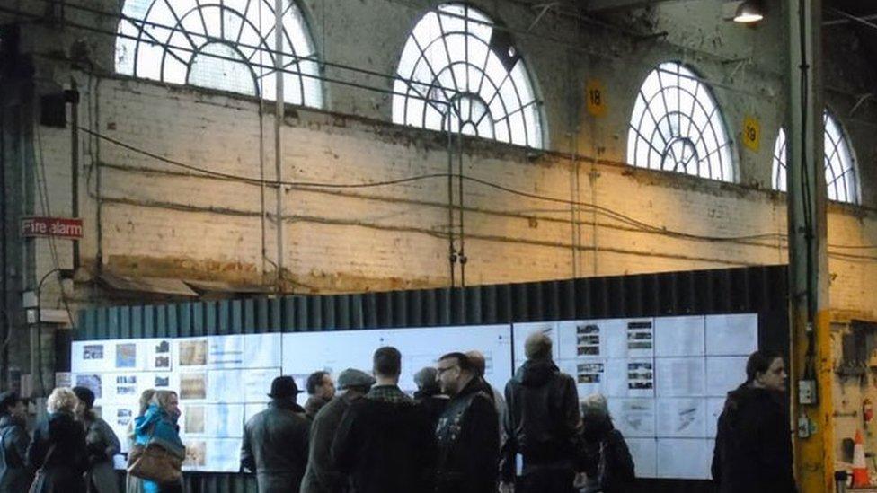 Local residents being shown the plans in the shell of the old building 18 months ago