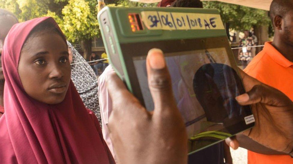 Official of the Independent National Electoral Commission (INEC) uses the Bimodal Voter Accreditation System (BVAS) during the Nigeria Presidential election at a polling station at the Federal Capital Territory, Abuja on February 25, 2023