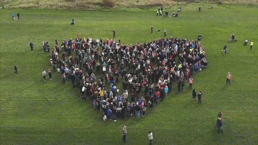 protestors make heart shape