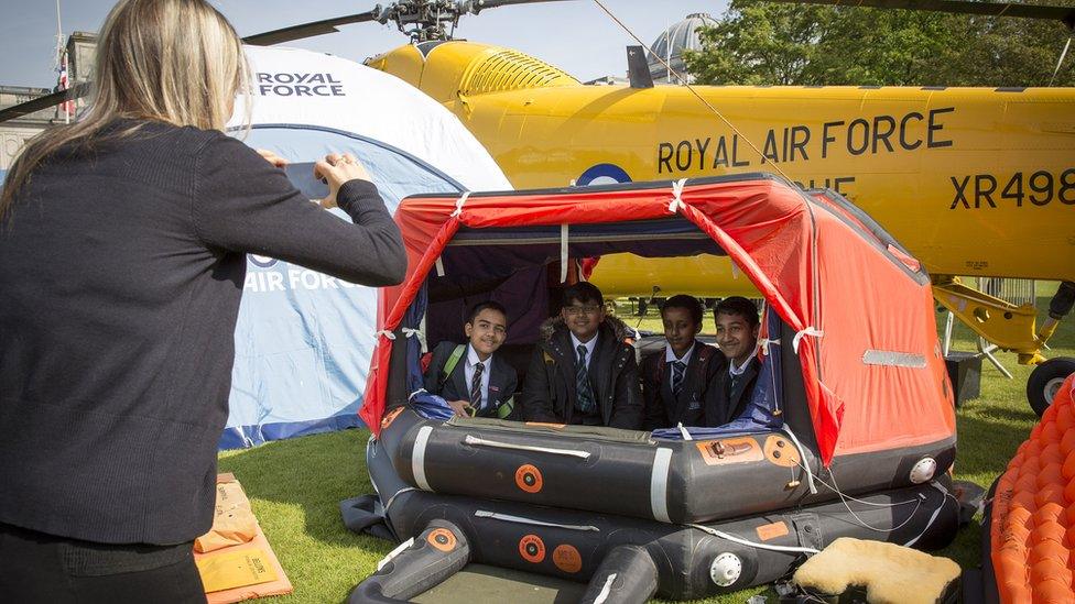 Youngsters at the RAF100 Aircraft Tour in Cardiff try out the rescue dinghy used by the RAF Wessex helicopter which was one of the aircraft on display.