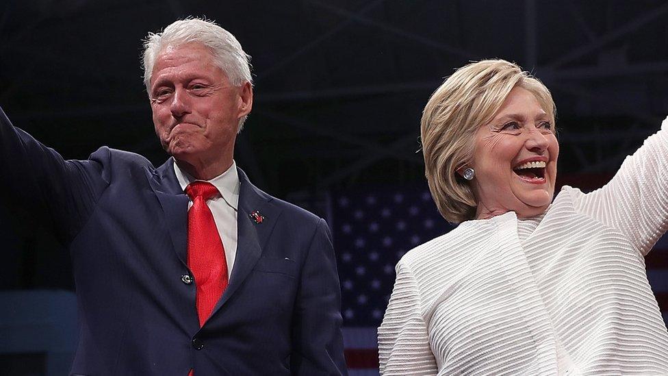 Hillary Clinton and Bill Clinton wave during a campaign event.