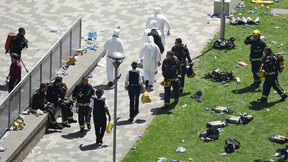 Police, firefighters and forensic science teams outside Grenfell Tower